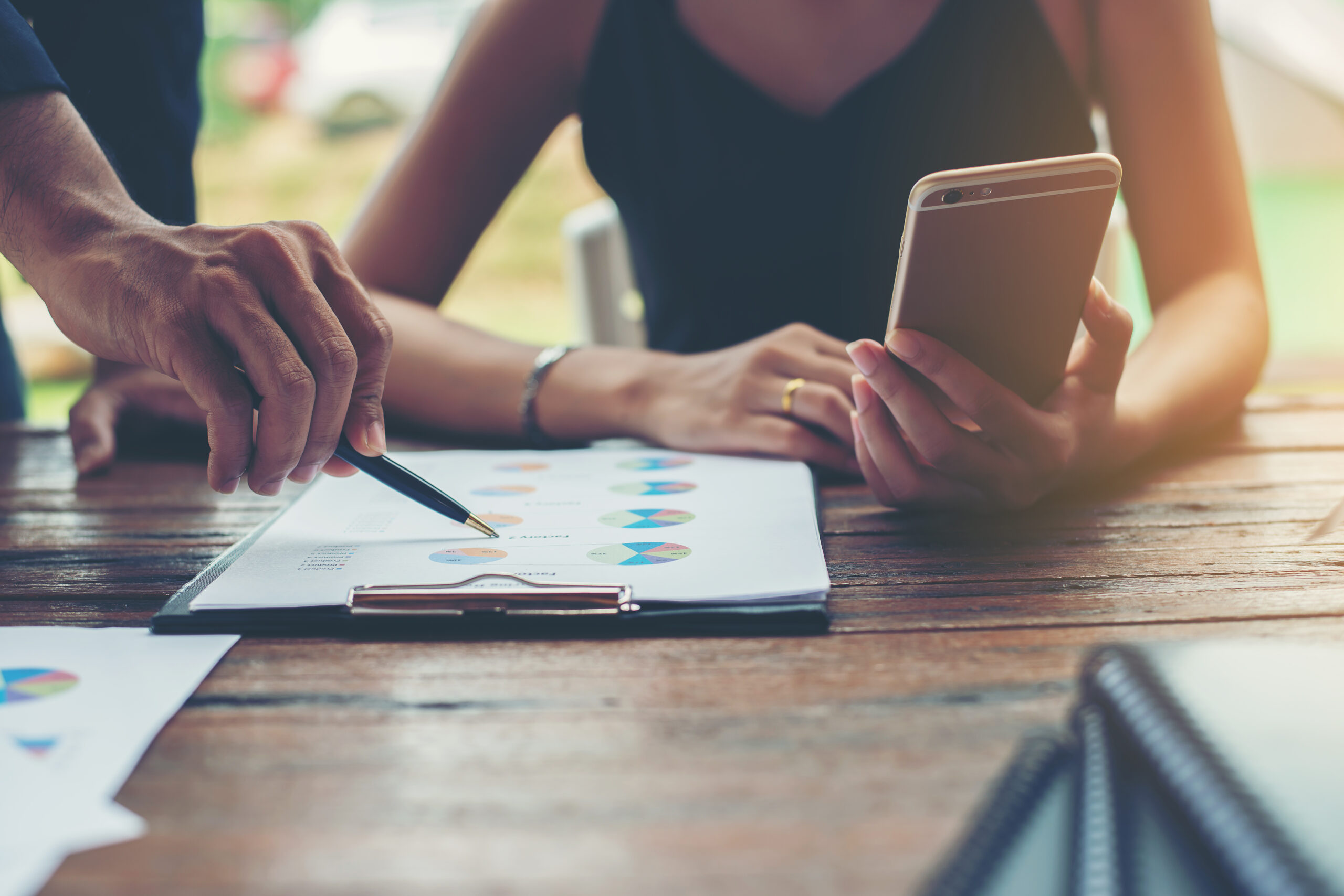 Coworkers reviewing data charts on a document