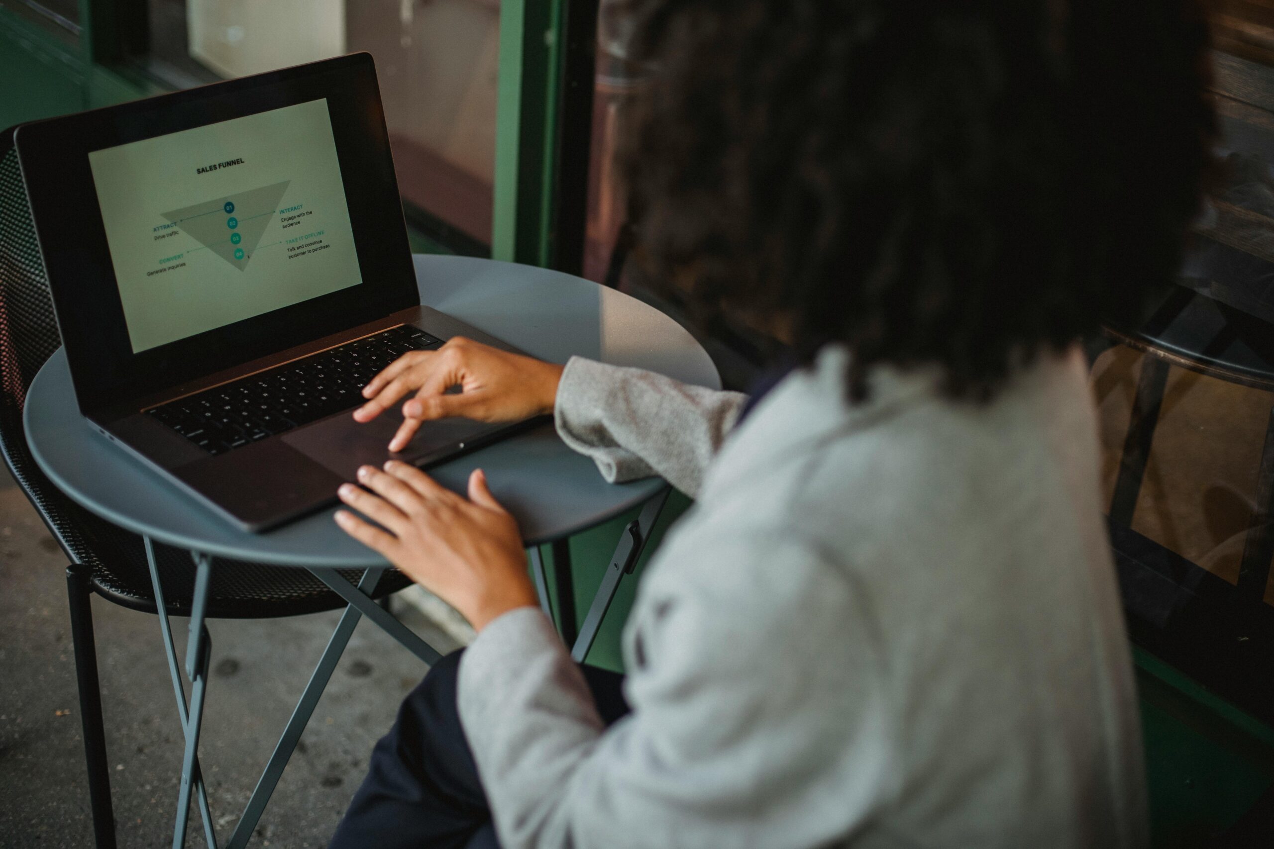 A woman analyzing a diagram on a laptop